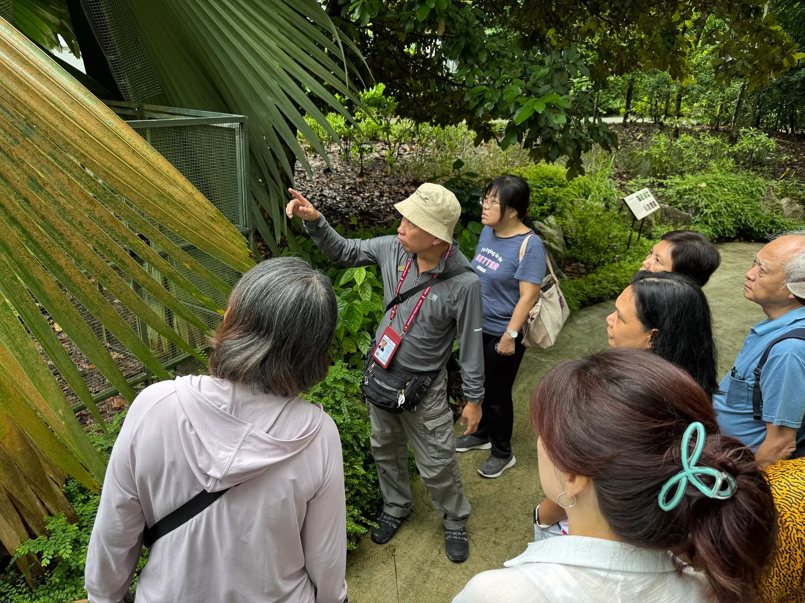 A Serai guide pointing out a plant detail at the Botanic Gardens