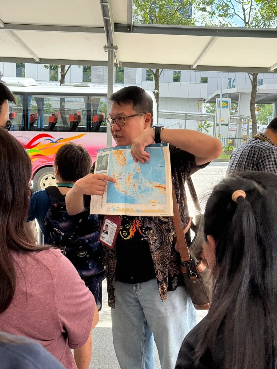 A Serai guide sharing an old photograph with guests on a walking experience