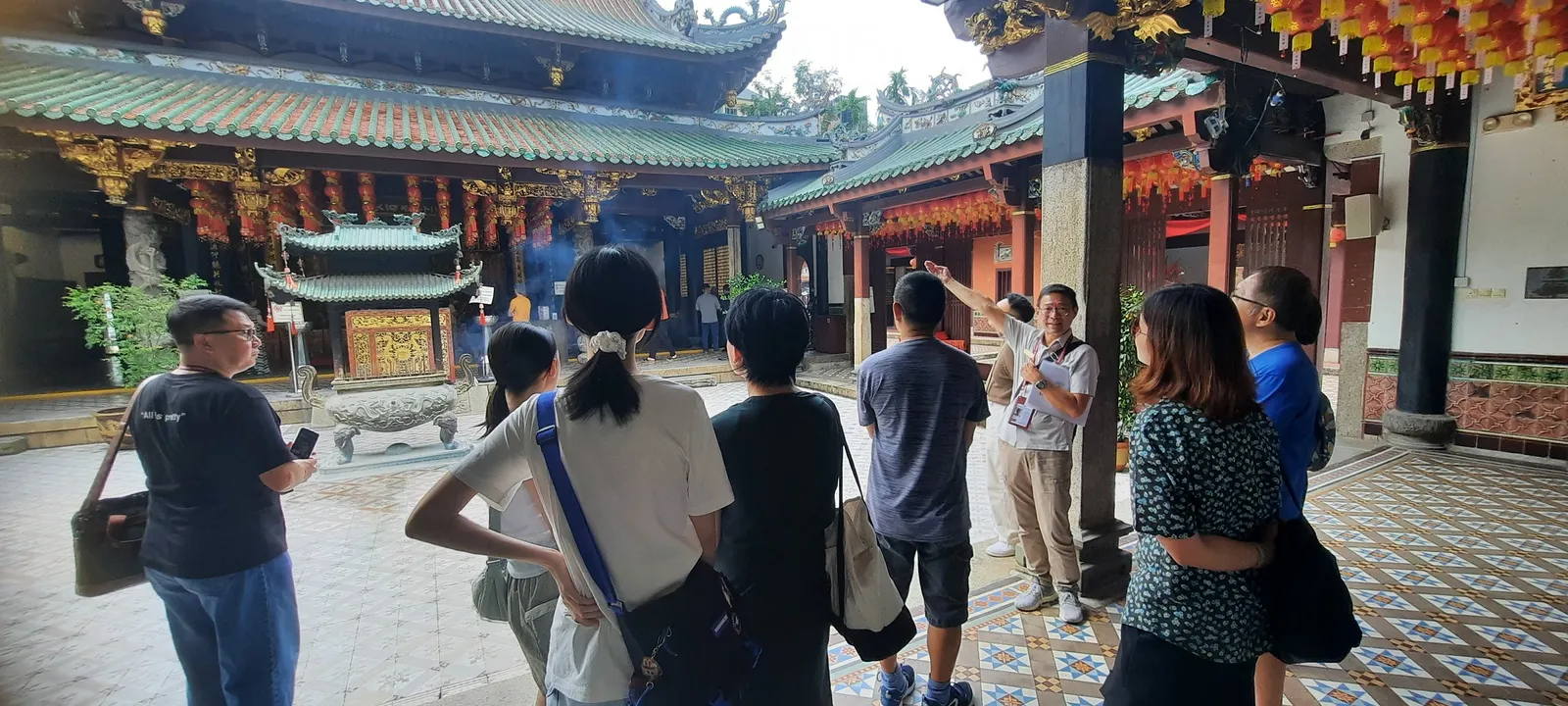 A guided group in a Chinatown temple courtyard